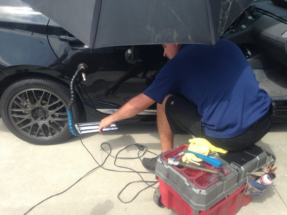 Matt working on a customer vehicle in a driveway